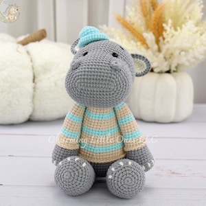 blue crochet hippo plush, grey hippo wearing blue hat