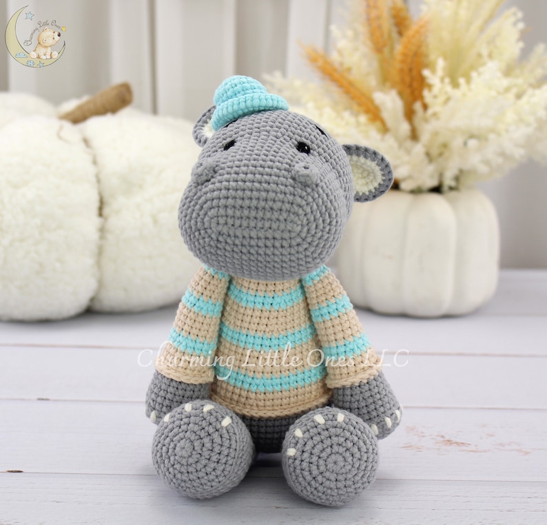 blue crochet hippo plush, grey hippo wearing blue hat