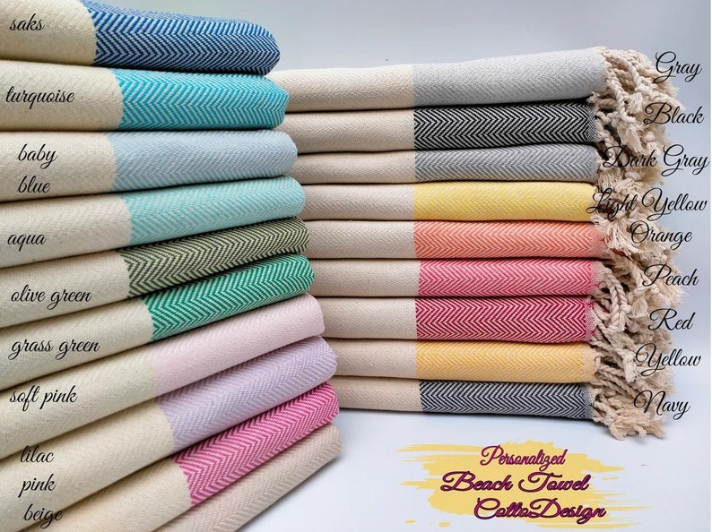 May include: A stack of colorful beach towels with a herringbone pattern. The towels come in various colors, including blue, green, pink, and yellow, with a white border and fringe. The text "Personalized Beach Towel Calla Design" is visible.