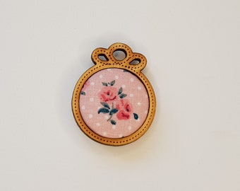 Magnetic needle holder accessory for embroidery and handmade sewing in wood and romantic pink fabrics