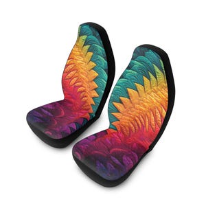 May include: Two car seat covers with a vibrant, abstract design. The pattern features a blend of colors, including purple, red, orange, yellow, and teal, creating a dynamic and eye-catching visual. The covers have a black border and are designed to fit standard car seats.