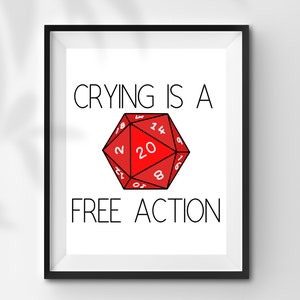 Peut inclure: Impression encadrée avec le texte "CRYING IS A FREE ACTION" au-dessus d'un dé rouge à vingt faces. Le dé a des chiffres blancs et est centré sur un fond blanc.