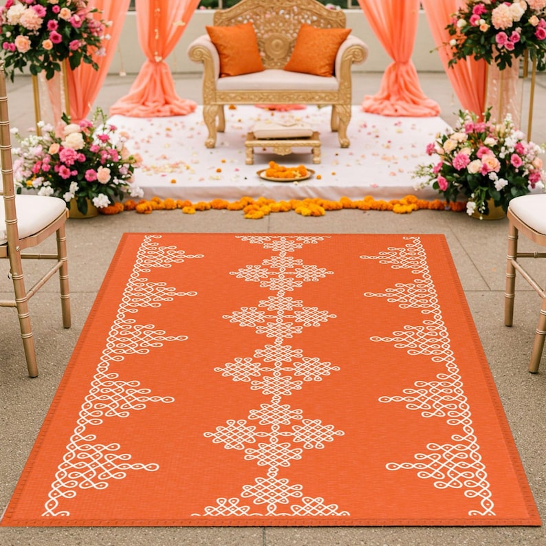May include: A white and orange patterned wedding aisle runner with a traditional Indian design. The runner is made of a durable material and is perfect for outdoor ceremonies.