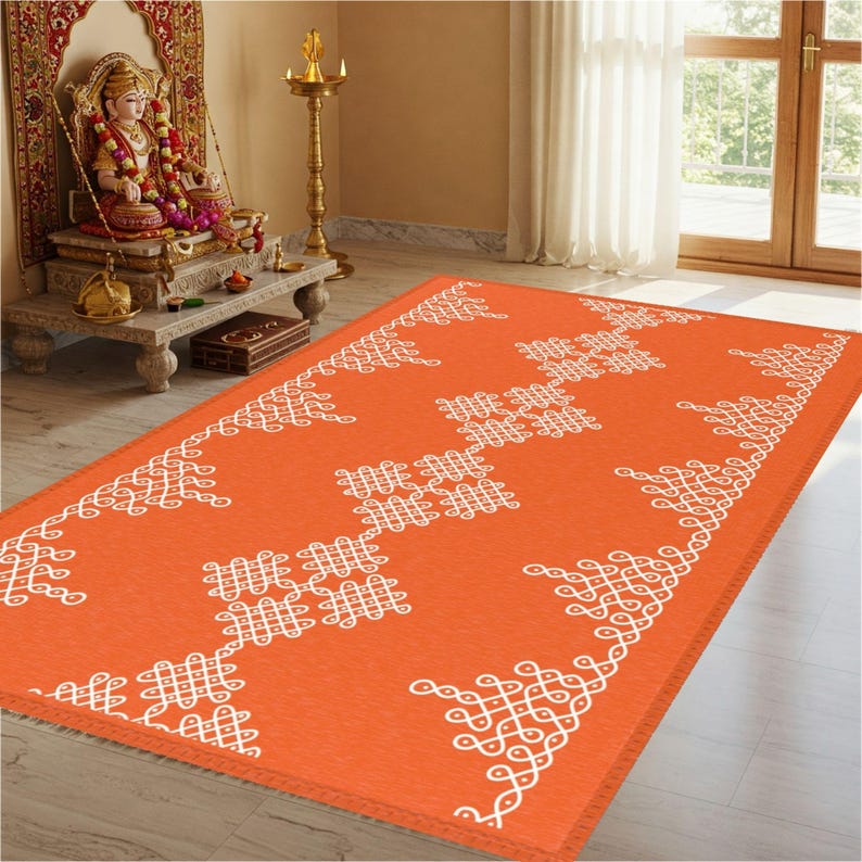 May include: Orange and white patterned rug with a traditional Indian design. The rug has a fringed edge and is made of a soft, durable material.