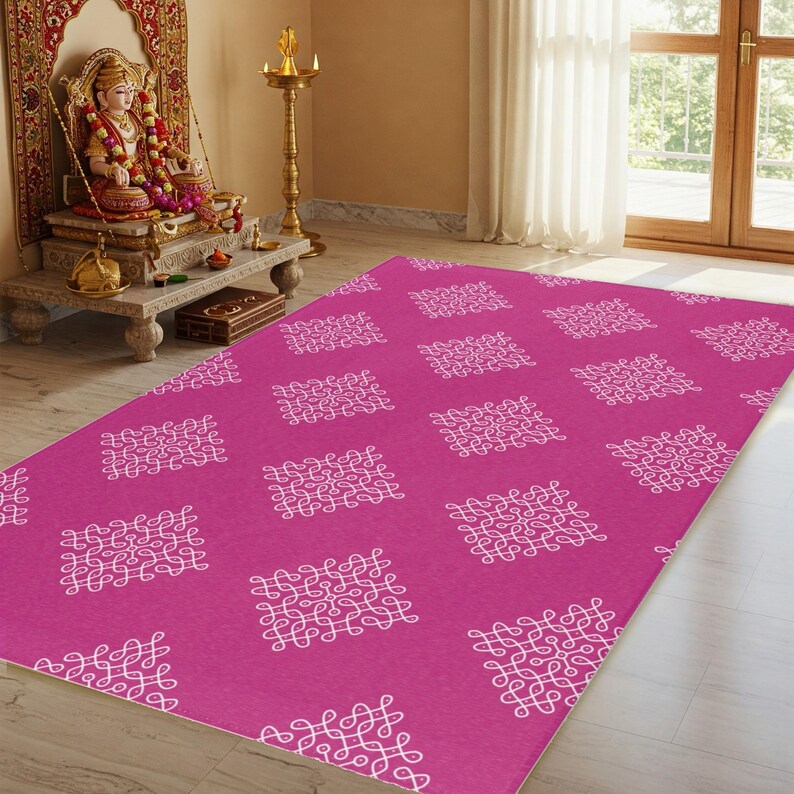 May include: A pink rug with a white geometric pattern. The pattern is made up of repeating squares with intricate designs.