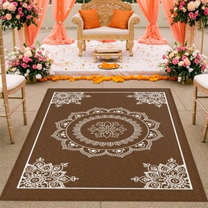 May include: A brown rectangular rug with a white mandala design. The rug has a large mandala in the center and four smaller mandalas in the corners. The rug is perfect for adding a touch of bohemian style to any room.