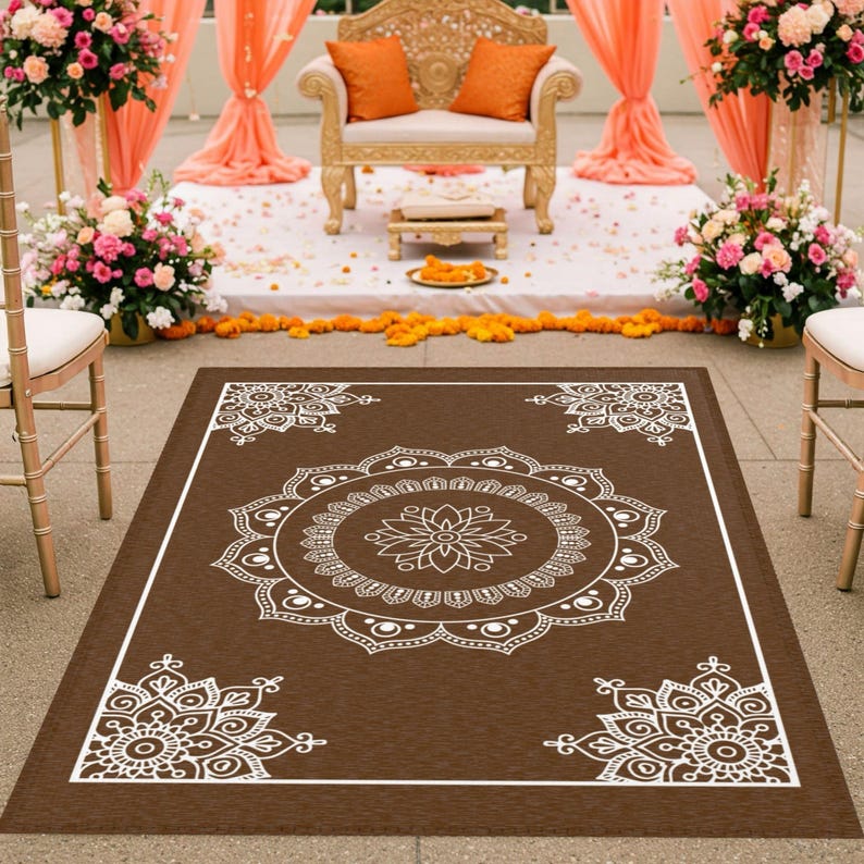 May include: A brown rectangular rug with a white mandala design. The rug has a large mandala in the center and four smaller mandalas in the corners. The rug is perfect for adding a touch of bohemian style to any room.