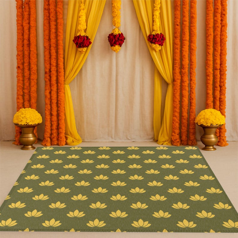May include: A green and yellow patterned rug with a lotus flower design. The rug is placed in front of a backdrop of yellow and orange fabric drapes with floral garlands.