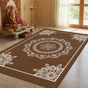 May include: A brown area rug with a white mandala design. The rug has a white border and features several intricate mandala patterns.