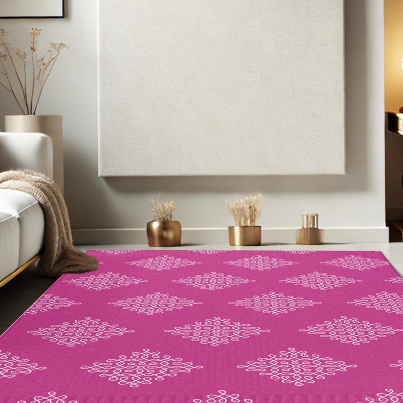 May include: A pink area rug with a white geometric pattern. The rug has a repeating pattern of white, intricate designs on a solid pink background.