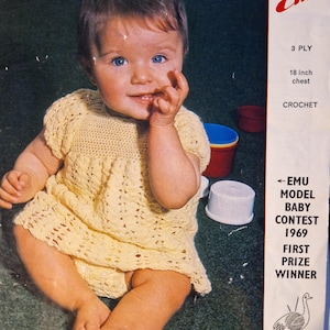 May include: A vintage photograph features a baby wearing a yellow crochet dress. The image includes text that reads "Emu Model Baby Contest 1969 First Prize Winner." The dress has an 18-inch chest measurement.