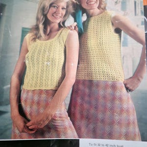 May include: Two women wearing sleeveless crocheted tops in yellow. The tops are made with a lacy stitch. The women are wearing skirts with a plaid pattern in shades of pink, purple, and yellow. The image includes the text "Ladyship Wools" and "To fit 32 to 42 inch bust".