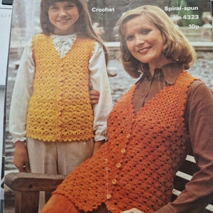 May include: Two crocheted vests, one yellow and one orange, are shown on a woman and a girl. The pattern is called "Spiral-spun" and the number is 4323. The text "Crochet" is also visible.