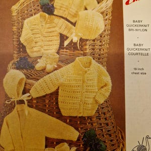May include: A vintage knitting pattern for a baby's knitted outfit, including a cardigan, hat, and booties. The pattern is for a 19-inch chest size and is called "Emu" with the brand name "Baby Quickerknit".