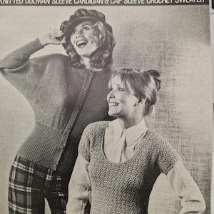 May include: A vintage knitting pattern featuring two women wearing a cardigan and a crochet sweater. The pattern is for a dolman sleeve cardigan and a cap sleeve crochet sweater. The pattern is for sizes 32-38 inches bust.