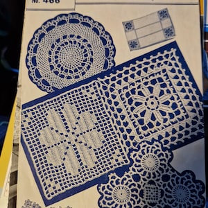 May include: A vintage crochet pattern booklet with a blue cover and white text. The title is "Weldons Motif Crochet" and the booklet number is 466. The cover features several crochet designs, including a doily, a table runner, and a placemat.