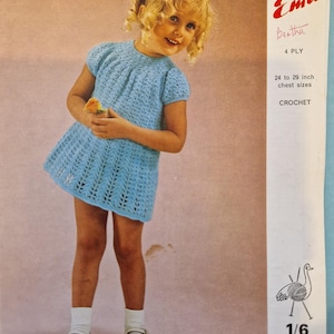 May include: A crochet pattern for a blue dress for a child. The pattern is called "Emu" and is for sizes 24 to 29 inches chest. The pattern is from a vintage book and is 1/6 of a 7p book.