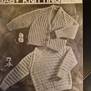 May include: A vintage knitting pattern for a baby cardigan and sweater. The pattern is for a size 18-22 inches chest and is free. The pattern is from Lee Target Baby Knitting and is number 9007.