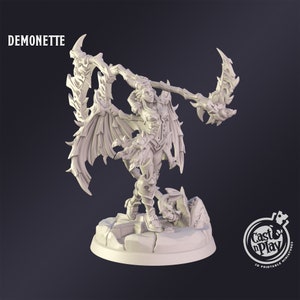 May include: A detailed, off-white figurine of a demonette, holding a large, ornate weapon. The figure has large wings and is standing on a rocky base. The word "DEMONETTE" is printed at the top. The Cast n Play logo is in the bottom right corner.