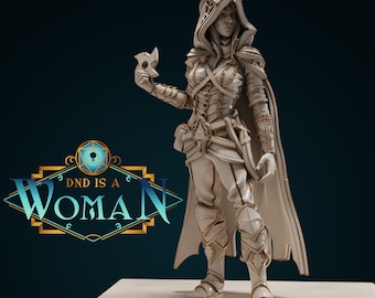 May include: A detailed white and gold figurine of a female character in fantasy armor, holding a mask. The figure is wearing a hooded cloak and is standing on a white surface. The image includes the text "DND IS A WOMAN".