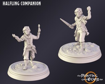 May include: Two white resin figurines of a Halfling Companion. One figure holds a spoon, the other a sword. Both are on circular bases. The text "HALFLING COMPANION" is at the top. The Printing Goes Ever On logo is at the bottom.