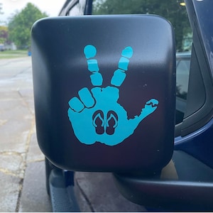 May include: A blue handprint decal with flip-flop silhouettes on a black car side mirror.