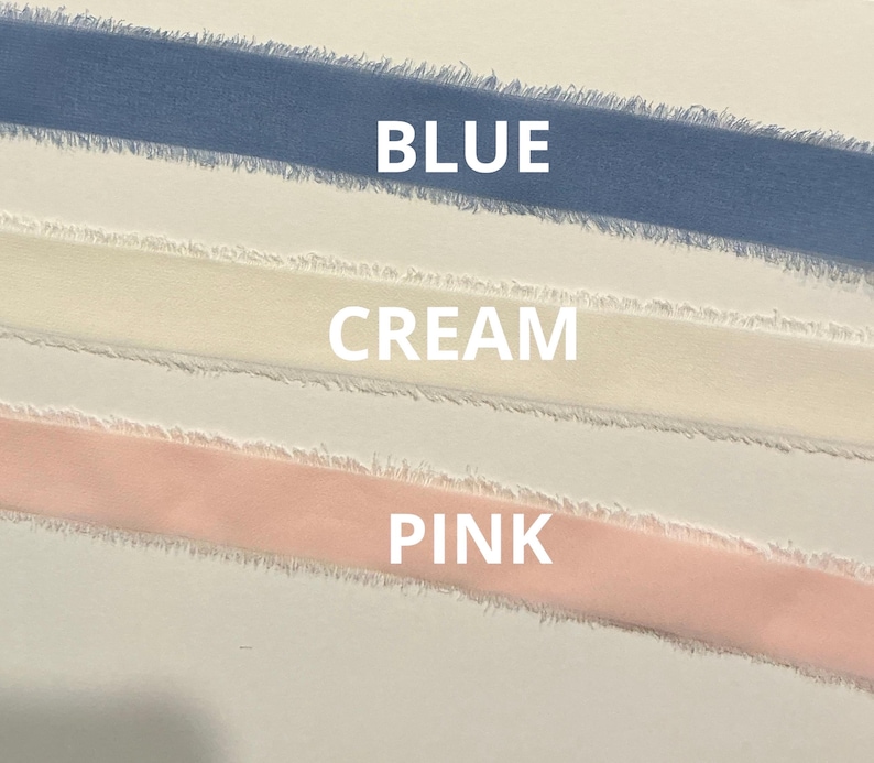 May include: Close-up of three ribbons in blue, cream, and pink. The word "BLUE" is above the blue ribbon, "CREAM" is above the cream ribbon, and "PINK" is above the pink ribbon. The ribbons have a frayed edge.