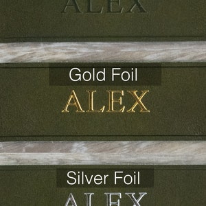 May include: Three samples of the name "ALEX" embossed on a dark green leather surface. The top sample is blind embossed, the middle sample is embossed with gold foil, and the bottom sample is embossed with silver foil.