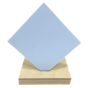 May include: A light blue square piece of acrylic on a wooden stand.