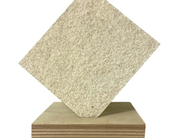 May include: A light beige, textured square panel is angled on top of a rectangular wooden base. The base is made of layered plywood. The panel appears to be made of a composite material.