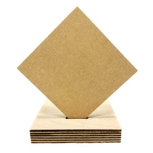 May include: A square piece of brown wood with a rough texture, standing on a base made of multiple layers of plywood.