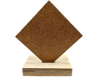 May include: A geometric wooden sculpture featuring a large, brown, diamond-shaped piece balanced on a rectangular wooden base. The diamond is angled, creating a dynamic visual effect. The base is made of light-colored wood.