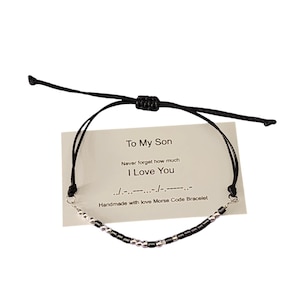May include: Black string bracelet with silver beads spelling "I Love You" in Morse code on a white card with the text "To My Son" and "Never forget how much I Love You". Handmade with love Morse Code Bracelet.