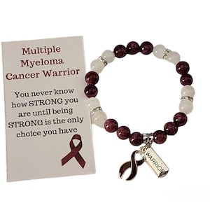 May include: A burgundy and white beaded bracelet with a silver charm featuring a ribbon and the word "WARRIOR". The bracelet comes with a card that reads "Multiple Myeloma Cancer Warrior" and includes a message of encouragement.