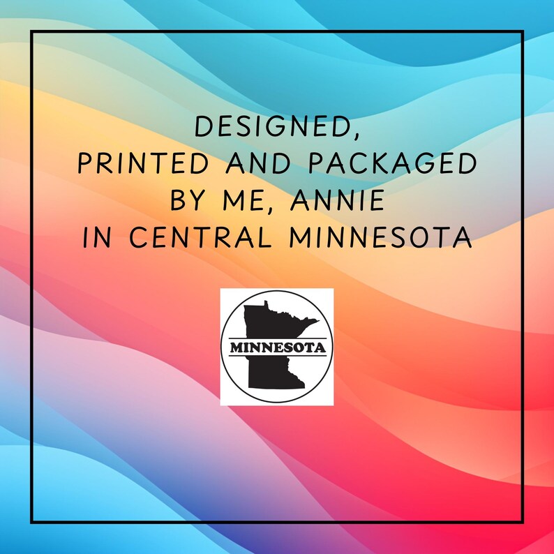 May include: A colorful background with a gradient of blue, yellow, orange, and red. The text reads "DESIGNED, PRINTED AND PACKAGED BY ME, ANNIE IN CENTRAL MINNESOTA." A black and white Minnesota state outline is in a circle.