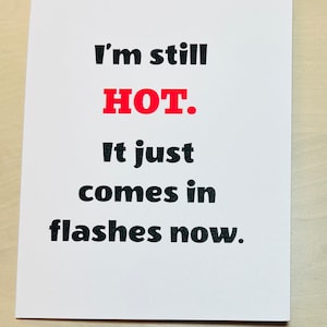 May include: White card with black text that reads "I'm still HOT. It just comes in flashes now.". The word "HOT" is in red.