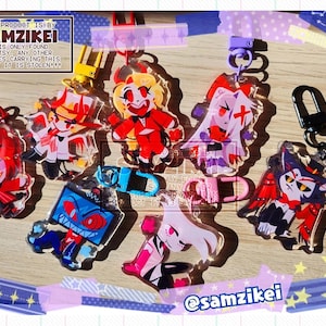May include: A collection of six acrylic character keychains featuring vibrant, stylized illustrations of animated figures with red, white, blue, and black color schemes. Each keychain includes a colorful plastic clasp for attachment.