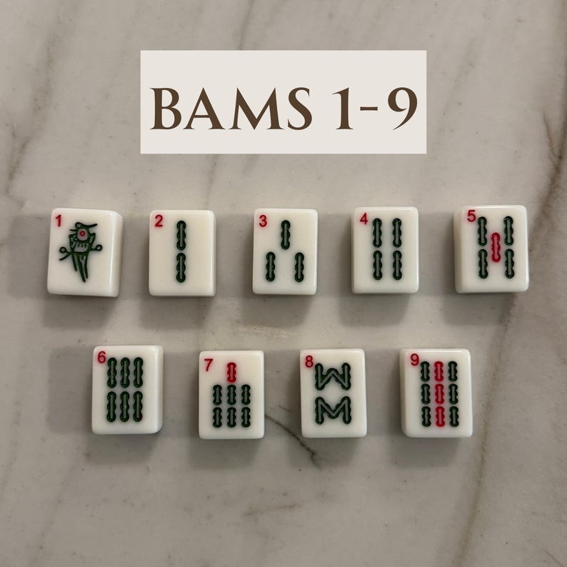 May include: Nine white Mahjong tiles, numbered 1-9, with black and red markings. The tiles are arranged in a grid, with the text "BAMS 1-9" above them. The tiles are for the "Bams" suit.