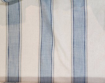 May include: White fabric with blue stripes. The fabric is folded in half and the stripes are running vertically.