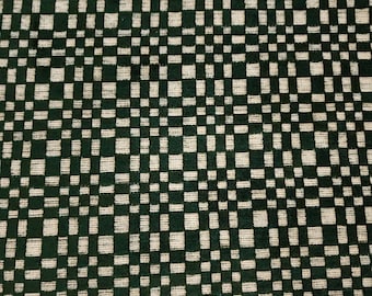 May include: Green and white checkered fabric with a woven texture.