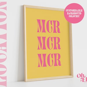 May include: A framed print with the text "MCR" repeated three times in a pink font on a yellow background. The frame is made of wood and has a natural finish. The print is titled "Oh Ellie Studio".