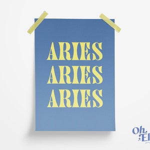 May include: A blue poster with the word "ARIES" repeated three times in a yellow font. The poster is taped to a white wall.