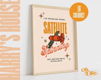 May include: A retro-style illustration of a satellite spinning in space with the text "I go 'round and 'round... Satellite Spinning Out, waiting for ya to pull me in." The illustration is in a peachy-orange color scheme with a wooden frame.