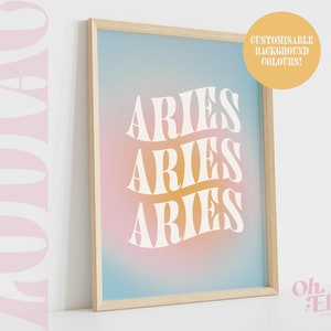 May include: A framed print with a gradient background in shades of blue, pink, and yellow. The word "ARIES" is repeated three times in a white, stylized font.