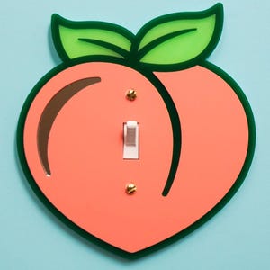 May include: A rustic wooden sign with the text "Welcome to our home" in white lettering. The sign features a distressed finish and a simple, inviting design, perfect for a front porch or entryway.