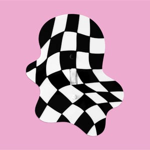 May include: A decorative light switch cover with a black and white checkered pattern. The cover has a unique, wavy shape and a standard light switch. The background is a solid pink color.