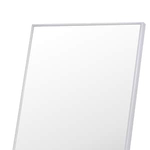 May include: A silver framed rectangular mirror with a beveled edge.