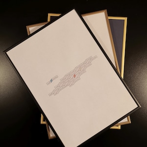 May include: A white framed print with the words "wall bonito" repeated in a pattern. The words are arranged in a diagonal line from the bottom left corner to the top right corner of the print.