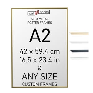May include: A slim gold metal poster frame with text reading wall bonito SLIM METAL POSTER FRAMES A2 42 x 59.4 cm 16.5 x 23.4 in & ANY SIZE CUSTOM FRAMES. To the right are four small frame profile samples in gold, white, black, and silver.