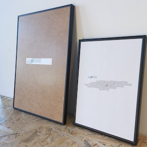 May include: Two framed prints, one with a brown background and the text "wall bonito" and the other with a white background and the text "wall bonito" repeated multiple times.
